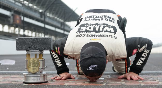 INDIANAPOLIS, INDIANA - JULY 25: Carson Kvapil, driver of the #1 Wilde Protein Crackers Chevrolet, kisses the yard of bricks after winning the NASCAR O'Reilly Auto Parts Series Pennzoil 250 Presented by Take 5 Oil Change at Indianapolis Motor Speedway on July 25, 2026 in Indianapolis, Indiana. (Photo by Logan Riely/Getty Images) | Getty Images