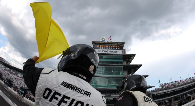 INDIANAPOLIS, INDIANA - JULY 27: A NASCAR Official waves the yellow caution flag during the NASCAR Cup Series Brickyard 400 Presented by PPG at Indianapolis Motor Speedway on July 27, 2025 in Indianapolis, Indiana. (Photo by Jonathan Bachman/Getty Images) | Getty Images
