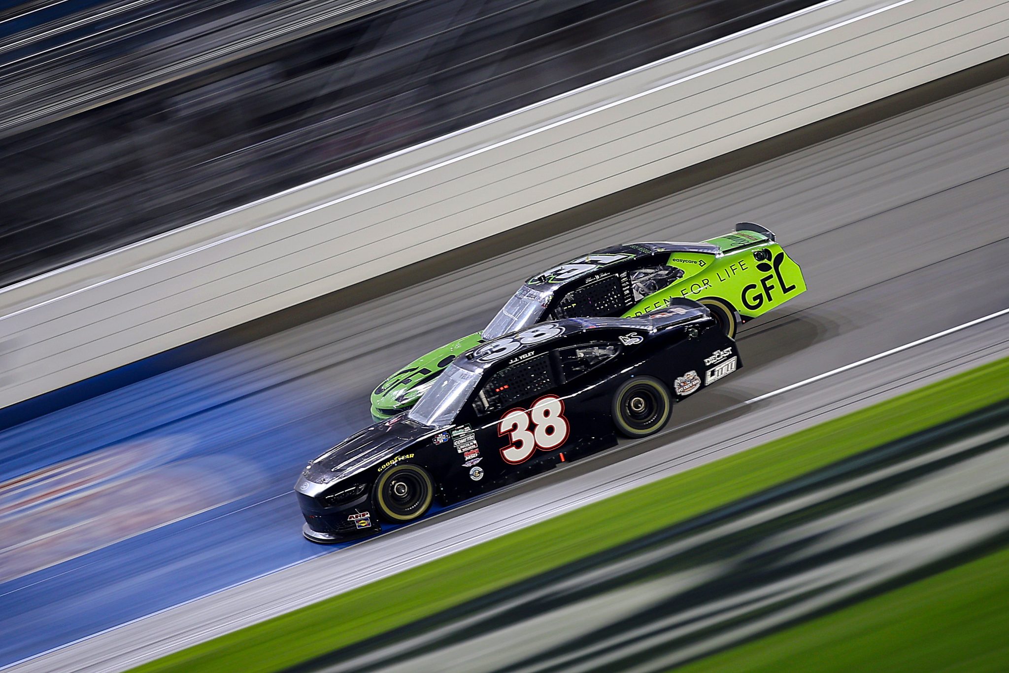 JOLIET, ILLINOIS - JULY 04: JJ Yeley, driver of the #38 Ford, and Blaine Perkins, driver of the #31 GFL Green for Life Chevrolet, race during the NASCAR O'Reilly Auto Parts Series Cuervo 300 at Chicagoland Speedway on July 04, 2026 in Joliet, Illinois. (Photo by Jonathan Bachman/Getty Images) | Getty Images