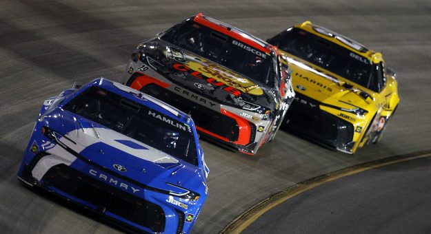 LEBANON, TENNESSEE - MAY 31: Denny Hamlin, driver of the #11 Progressive Insurance Toyota, Chase Briscoe, driver of the #19 Bass Pro Shops Toyota, and Christopher Bell, driver of the #20 DeWalt Toyota, race during the NASCAR Cup Series Cracker Barrel 400 at Nashville Superspeedway on May 31, 2026 in Lebanon, Tennessee. (Photo by Sean Gardner/Getty Images) | Getty Images