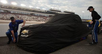 RICHMOND, VIRGINIA - AUGUST 14: Crew members cover the #26 Rackley Roofing Chevrolet driven by Dawson Sutton due to a weather delay of the NASCAR Craftsman Truck Series Black's Tire 250 presented by BTS Rewards at Richmond Raceway on August 14, 2026 in Richmond, Virginia. (Photo by Jonathan Bachman/Getty Images) | Getty Images