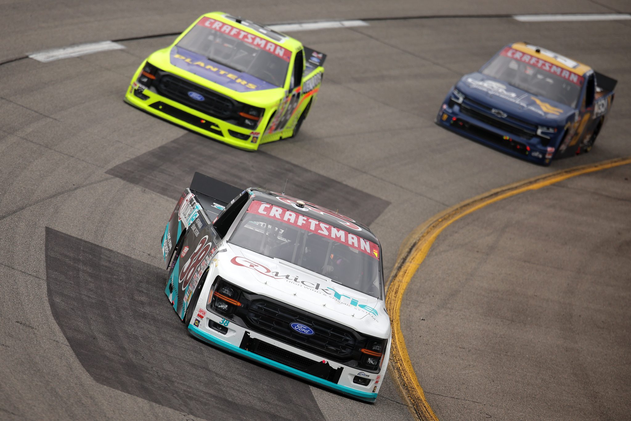 RICHMOND, VIRGINIA - AUGUST 15: Chandler Smith, driver of the #38 QuickTie Ford, Ty Majeski, driver of the #88 Planters/Menards Ford, and Grant Enfinger, driver of the #9 GCM - WVU Athletics Chevrolet, race during the NASCAR Craftsman Truck Series Black's Tire 250 presented by BTS Rewards at Richmond Raceway on August 15, 2026 in Richmond, Virginia. (Photo by Jonathan Bachman/Getty Images) | Getty Images