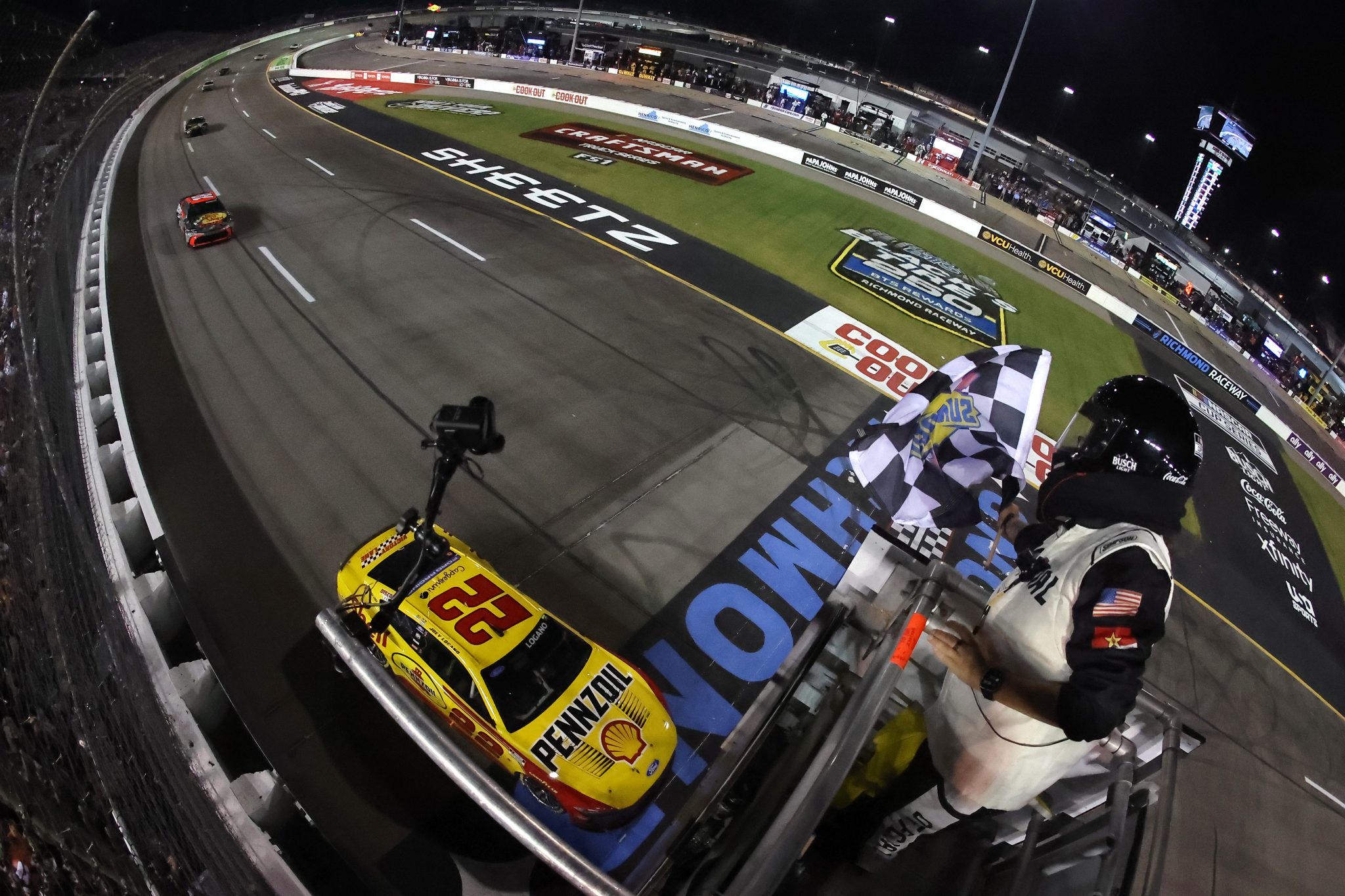 RICHMOND, VIRGINIA - AUGUST 15: Joey Logano, driver of the #22 Shell Pennzoil Ford, takes the checkered flag to win the NASCAR Cup Series Cook Out 400 at Richmond Raceway on August 15, 2026 in Richmond, Virginia. (Photo by Jonathan Bachman/Getty Images) | Getty Images