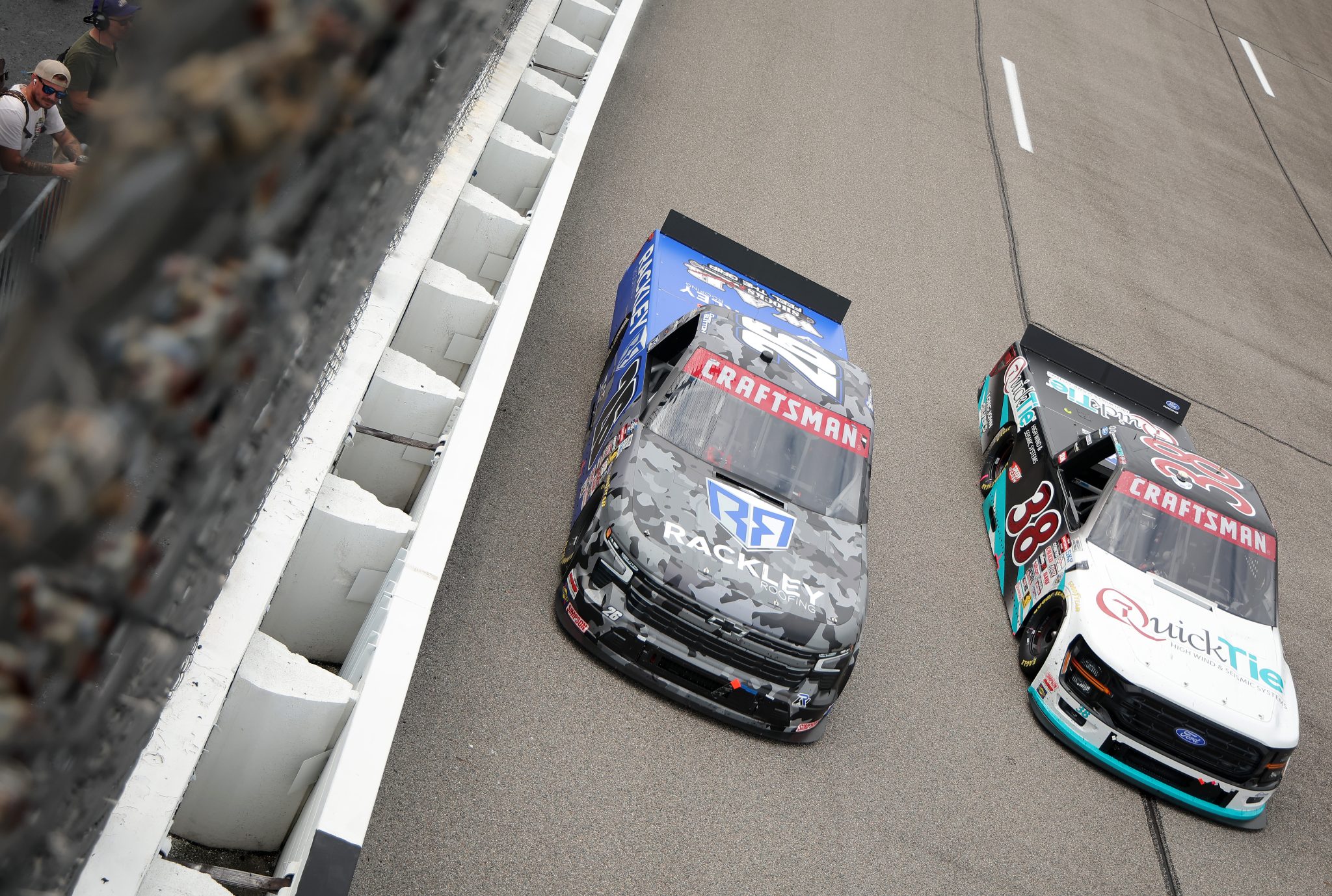 RICHMOND, VIRGINIA - AUGUST 15: Dawson Sutton, driver of the #26 Rackley Roofing Chevrolet, and Chandler Smith, driver of the #38 QuickTie Ford, race during the NASCAR Craftsman Truck Series Black's Tire 250 presented by BTS Rewards at Richmond Raceway on August 15, 2026 in Richmond, Virginia. (Photo by Jonathan Bachman/Getty Images) | Getty Images