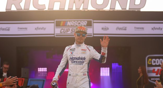 RICHMOND, VIRGINIA - AUGUST 15: Kyle Larson, driver of the #5 HendrickCars.com Chevrolet, waves to fans as he walks onstage during driver intros prior to the NASCAR Cup Series Cook Out 400 at Richmond Raceway on August 15, 2026 in Richmond, Virginia. (Photo by David Jensen/Getty Images) | Getty Images