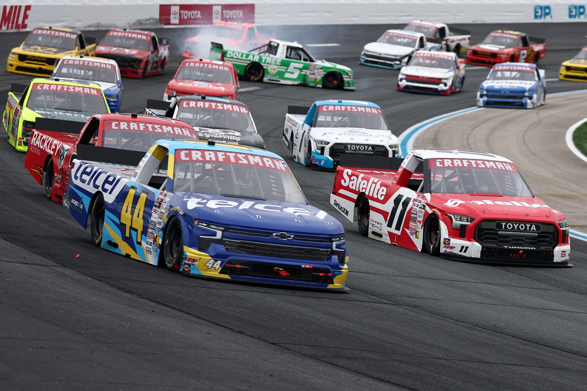 LOUDON, NEW HAMPSHIRE - AUGUST 22: Kaden Honeycutt, driver of the #11 Safelite Toyota, and Andres Perez De Lara, driver of the #44 Telcel Chevrolet, race as John Hunter Nemechek, driver of the #5 Dollar Tree Toyota, spin after an on-track incident during the NASCAR Craftsman Truck Series Team EJP 175 at New Hampshire Motor Speedway on August 22, 2026 in Loudon, New Hampshire. (Photo by Meg Oliphant/Getty Images) | Getty Images