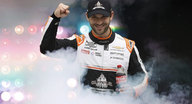 LOUDON, NEW HAMPSHIRE - AUGUST 23: Daniel Suarez, driver of the #7 Cal Ripken Sr. Foundation Chevrolet, waves to fans as he walks onstage during driver intros prior to the NASCAR Cup Series Dollar Tree 301 at New Hampshire Motor Speedway on August 23, 2026 in Loudon, New Hampshire. (Photo by Sean Gardner/Getty Images) | Getty Images
