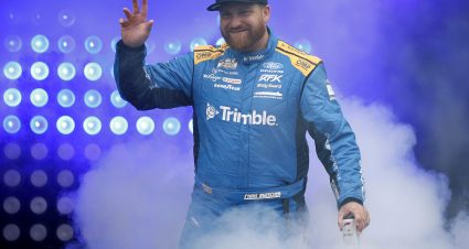 LOUDON, NEW HAMPSHIRE - AUGUST 23: Chris Buescher, driver of the #17 Trimble Ford, waves to fans as he walks onstage during driver intros prior to the NASCAR Cup Series Dollar Tree 301 at New Hampshire Motor Speedway on August 23, 2026 in Loudon, New Hampshire. (Photo by Sean Gardner/Getty Images) | Getty Images