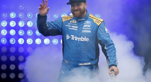 LOUDON, NEW HAMPSHIRE - AUGUST 23: Chris Buescher, driver of the #17 Trimble Ford, waves to fans as he walks onstage during driver intros prior to the NASCAR Cup Series Dollar Tree 301 at New Hampshire Motor Speedway on August 23, 2026 in Loudon, New Hampshire. (Photo by Sean Gardner/Getty Images) | Getty Images