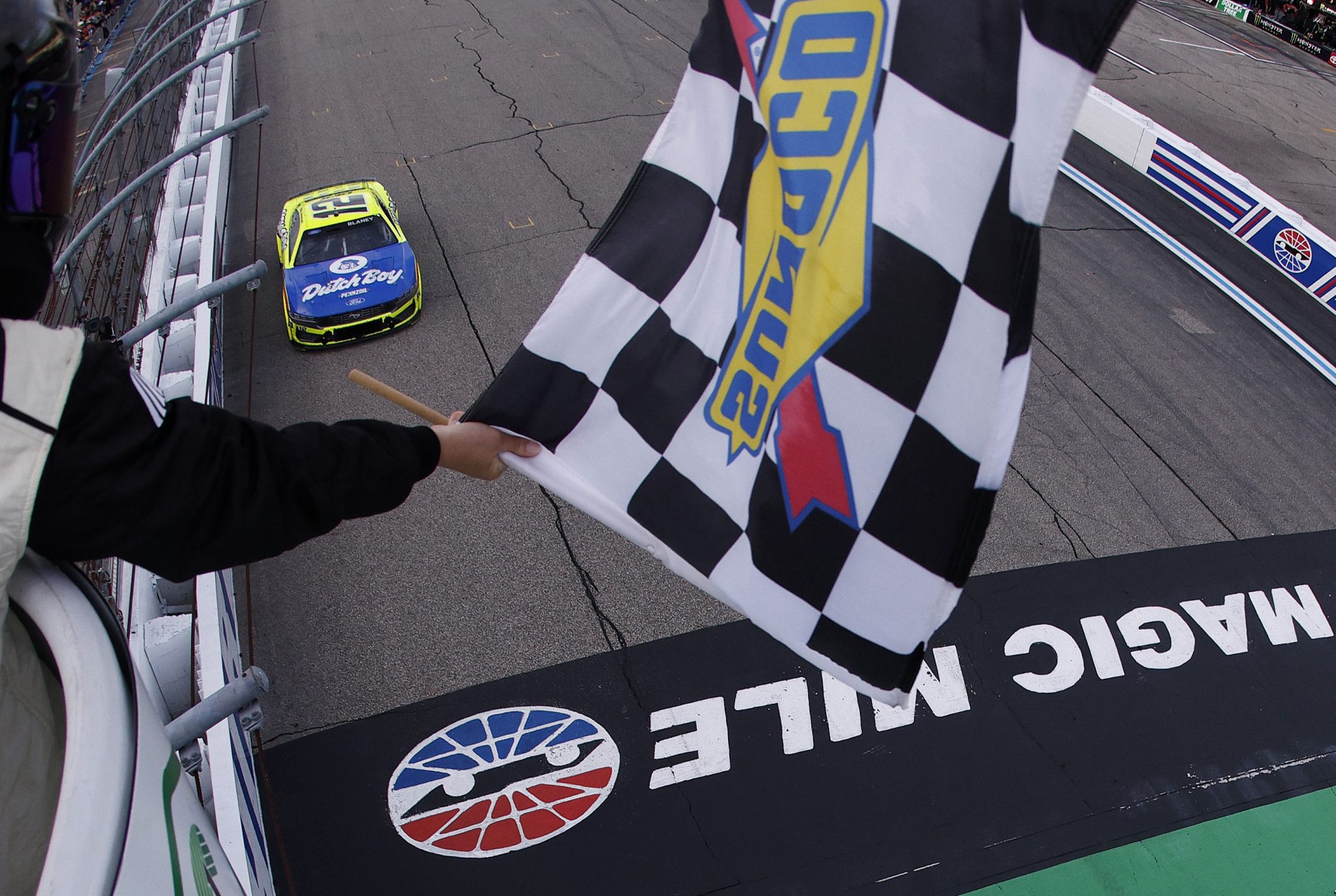 LOUDON, NEW HAMPSHIRE - AUGUST 23: Ryan Blaney, driver of the #12 Menards/Dutch Boy Ford, takes the checkered flag to win the NASCAR Cup Series Dollar Tree 301 at New Hampshire Motor Speedway on August 23, 2026 in Loudon, New Hampshire. (Photo by Sean Gardner/Getty Images) | Getty Images