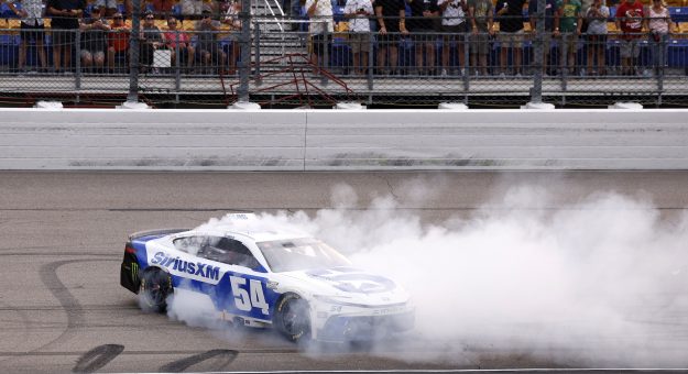 NEWTON, IOWA - AUGUST 09: Ty Gibbs, driver of the #54 SiriusXM Toyota, celebrates with a burnout after winning the NASCAR Cup Series Iowa Corn 350 Powered by Ethanol at Iowa Speedway on August 09, 2026 in Newton, Iowa. (Photo by Sean Gardner/Getty Images) | Getty Images