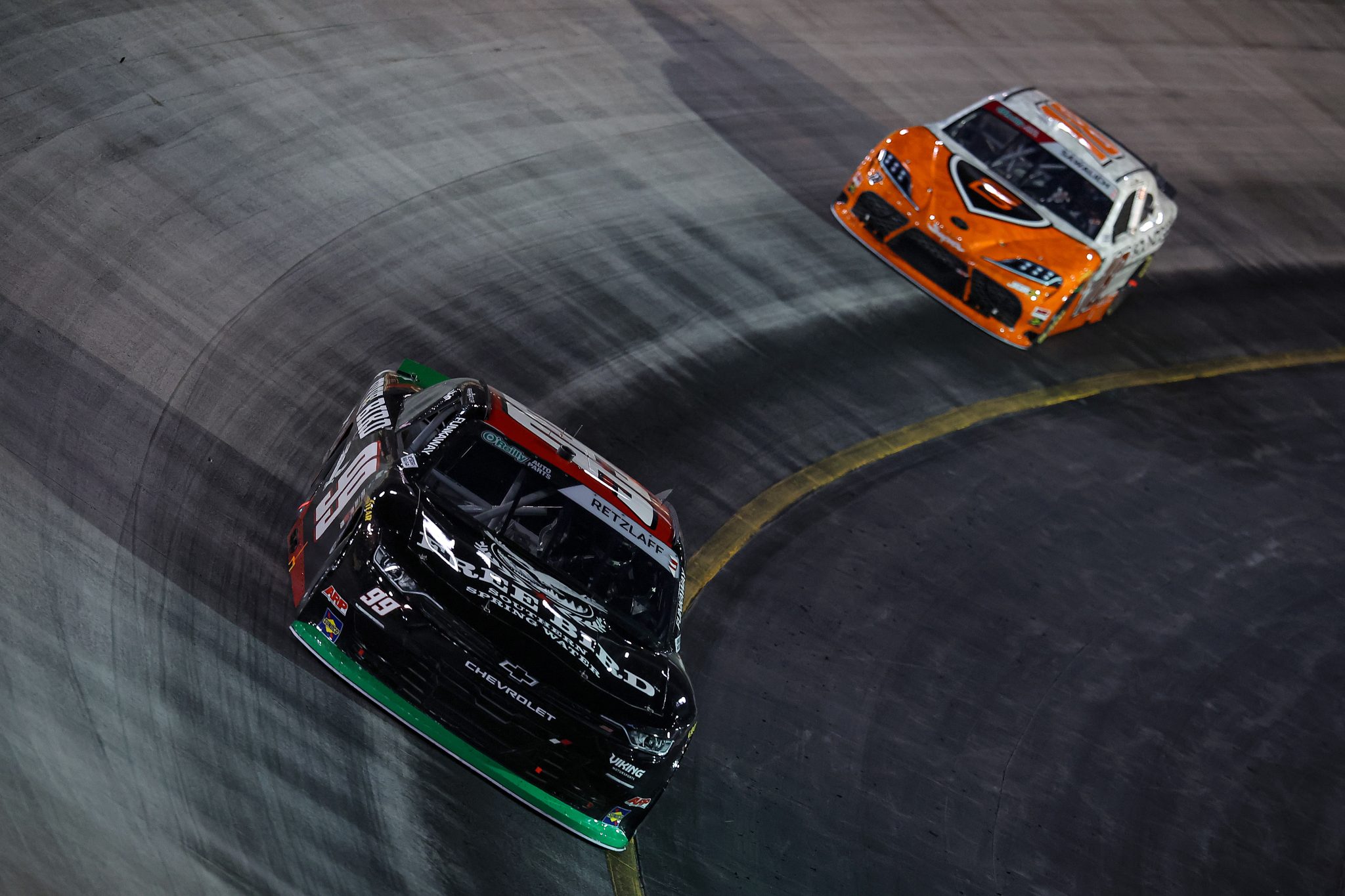 BRISTOL, TENNESSEE - SEPTEMBER 18: Parker Retzlaff, driver of the #99 Free Bird Southern Spring Water Chevrolet, and William Sawalich, driver of the #18 SoundGear Toyota, race during the NASCAR O'Reilly Auto Parts Series Food City 300 at Bristol Motor Speedway on September 18, 2026 in Bristol, Tennessee. (Photo by Jonathan Bachman/Getty Images) | Getty Images