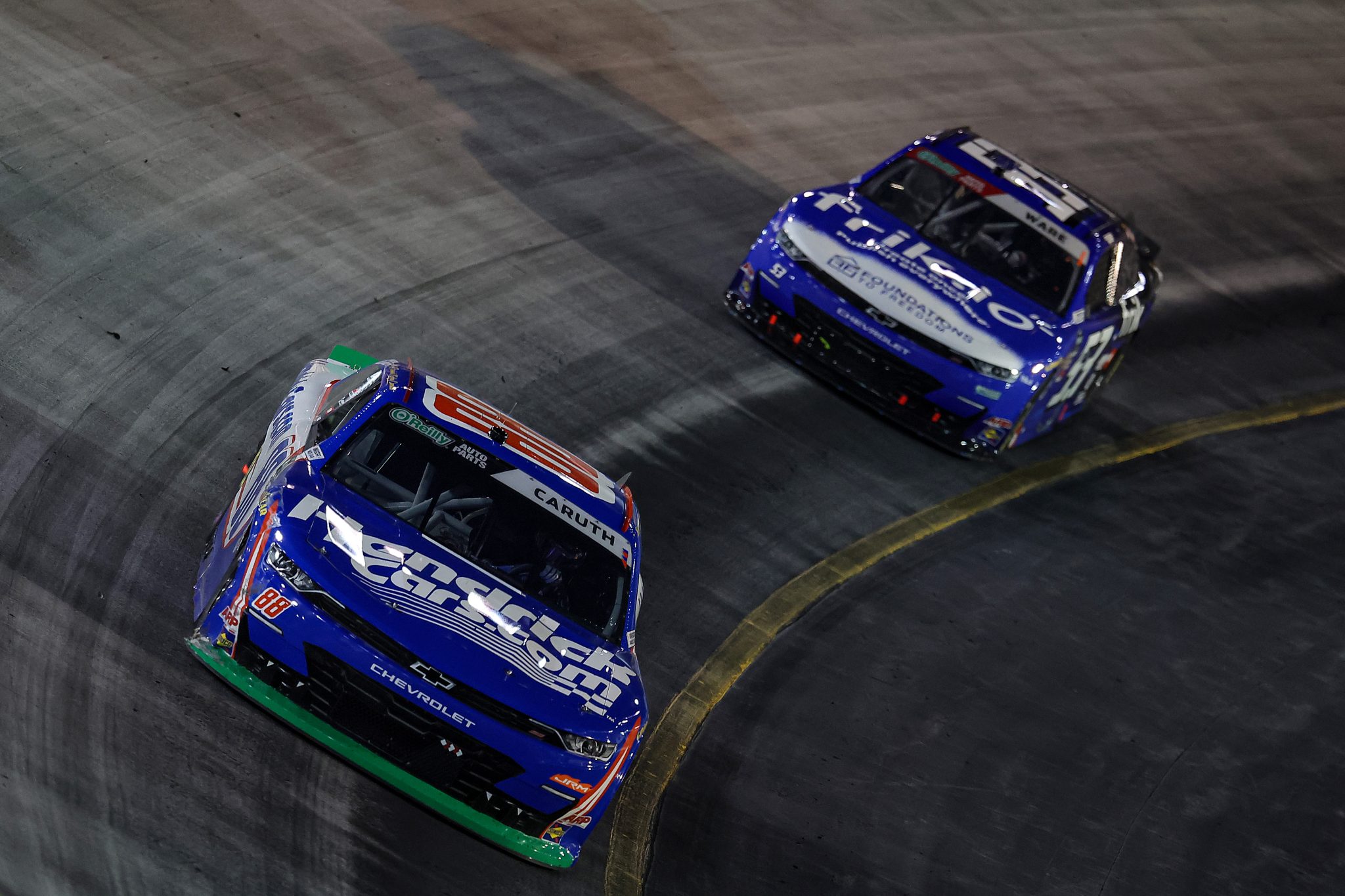 BRISTOL, TENNESSEE - SEPTEMBER 18: Rajah Caruth, driver of the #88 HendrickCars.com Chevrolet, and Carson Ware, driver of the #53 frik.io Chevrolet, race during the NASCAR O'Reilly Auto Parts Series Food City 300 at Bristol Motor Speedway on September 18, 2026 in Bristol, Tennessee. (Photo by Jonathan Bachman/Getty Images) | Getty Images