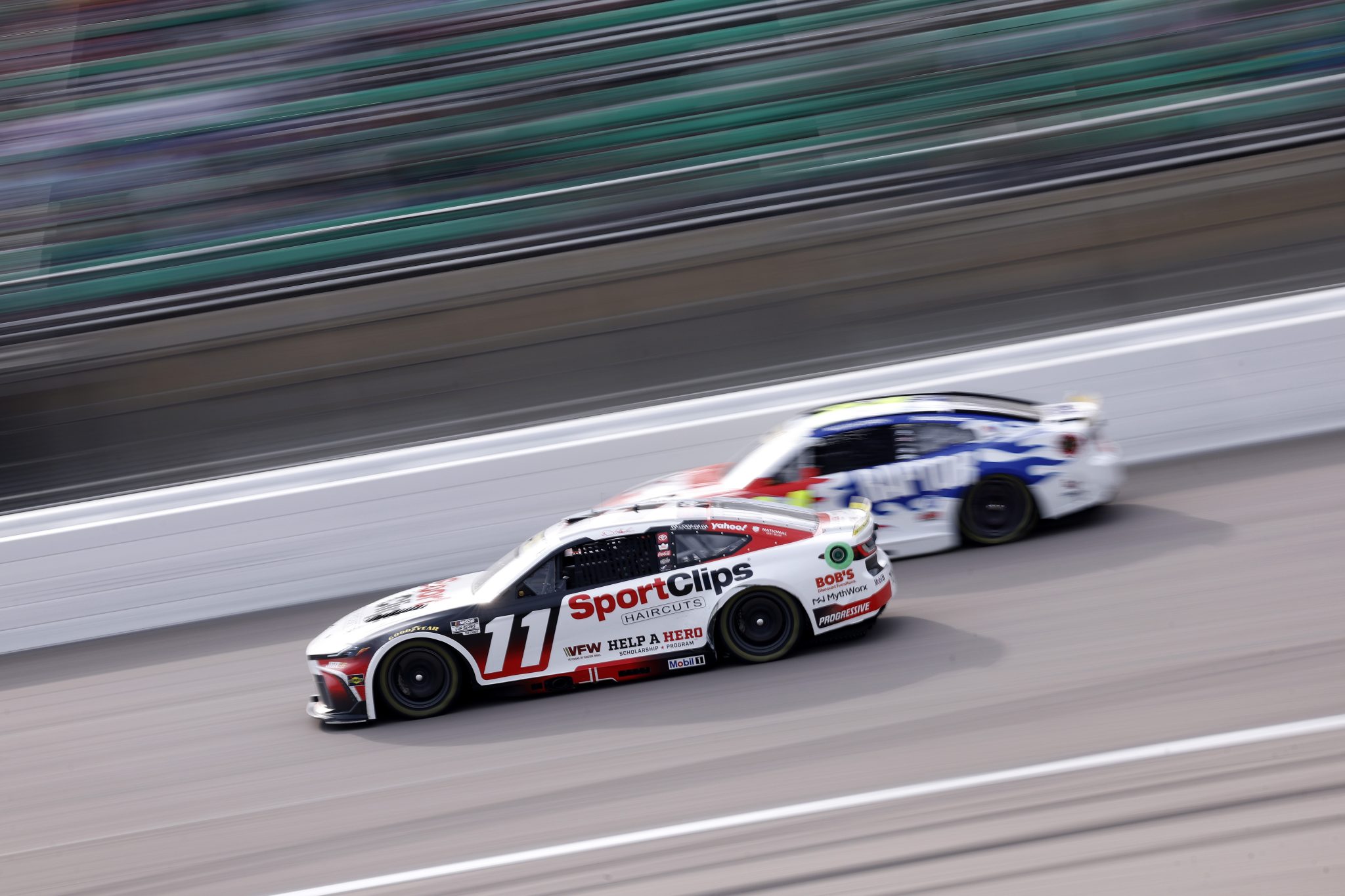 KANSAS CITY, KANSAS - SEPTEMBER 27: Denny Hamlin, driver of the #11 Sport Clips Haircuts Toyota, drives during the NASCAR Cup Series Hollywood Casino 400 at Kansas Speedway on September 27, 2026 in Kansas City, Kansas. (Photo by Sean Gardner/Getty Images) | Getty Images