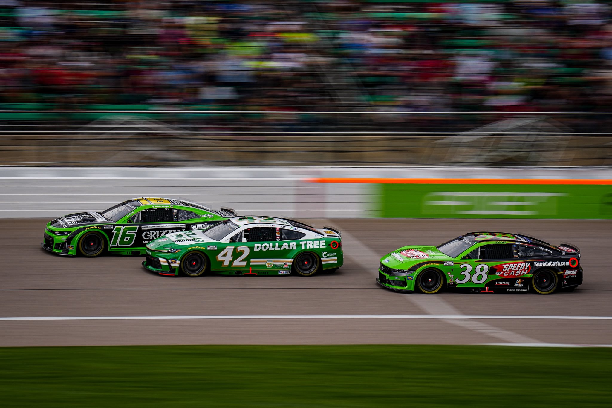 KANSAS CITY, KANSAS - SEPTEMBER 27: A.J. Allmendinger, driver of the #16 Grizzly Nicotine Pouches Chevrolet, John Hunter Nemechek, driver of the #42 Dollar Tree Toyota, and Zane Smith, driver of the #38 Speedy Cash Ford, drives during the NASCAR Cup Series Hollywood Casino 400 at Kansas Speedway on September 27, 2026 in Kansas City, Kansas. (Photo from Kaulig Racing)