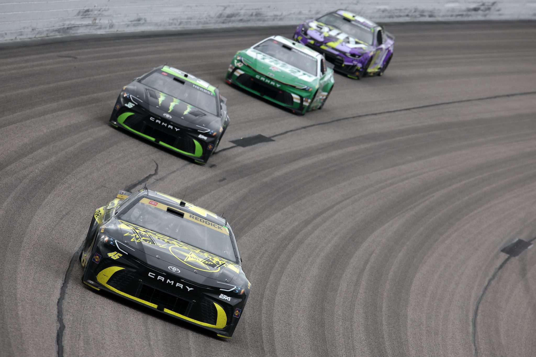 KANSAS CITY, KANSAS - SEPTEMBER 27: Tyler Reddick, driver of the #45 ROCKSTAR ENERGY DRINK Toyota, Riley Herbst, driver of the #35 Monster Energy Toyota, John H. Nemechek, driver of the #42 Dollar Tree Toyota, and Alex Bowman, driver of the #48 Ally Chevrolet, race during the NASCAR Cup Series Hollywood Casino 400 at Kansas Speedway on September 27, 2026 in Kansas City, Kansas. (Photo by Jonathan Bachman/Getty Images) | Getty Images