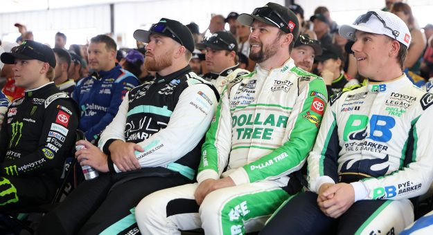 LONG POND, PENNSYLVANIA - JUNE 14: (L-R) Ty Gibbs, driver of the #54 Monster Energy Toyota, Chris Buescher, driver of the #17 BuildSubmarines.com Ford, Erik Jones, driver of the #43 Dollar Tree Toyota, and John H. Nemechek, driver of the #42 Pye-Barker Fire & Safety Toyota, attend the during the drivers meeting prior to the NASCAR Cup Series Great American Getaway 400 presented by VISITPA at Pocono Raceway on June 14, 2026 in Long Pond, Pennsylvania. (Photo by James Gilbert/Getty Images) | Getty Images